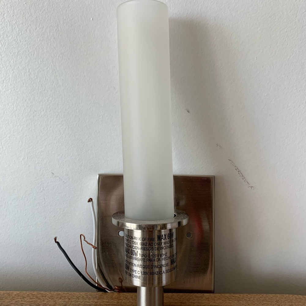 Two brand new stainless steel wall sconces.